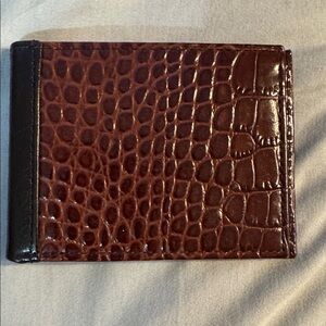 A Neiman Marcus brown crocodile-embossed leather bifold wallet.